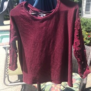 Red shirt with sleeve design and open back.